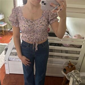 Floral purple crop top with puffy sleeves and a tie in front